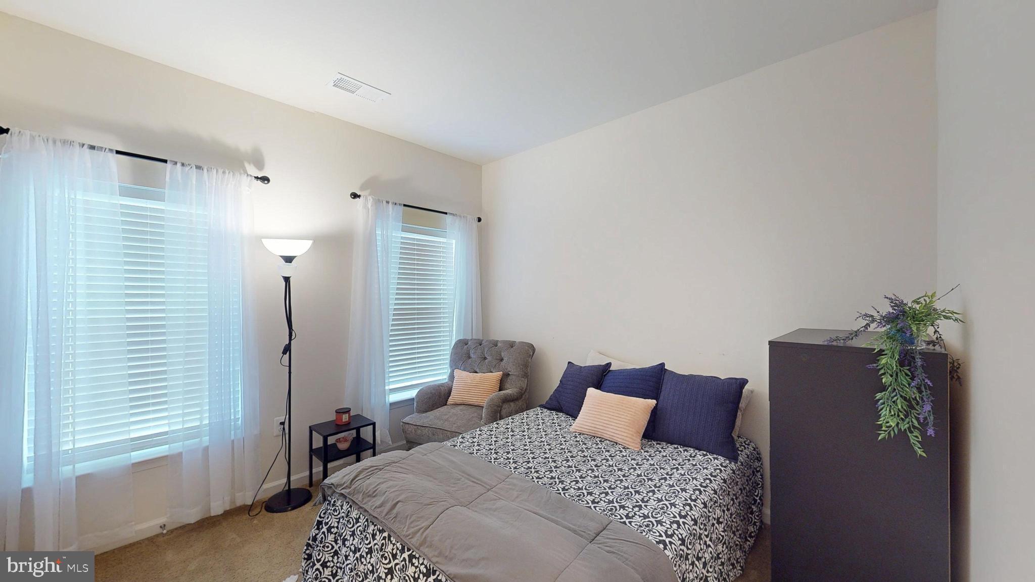 15103 Hogshead Way Upper Marlboro, MD 20772 - Photo 31 of 44 a bedroom with a large bed and a potted plant