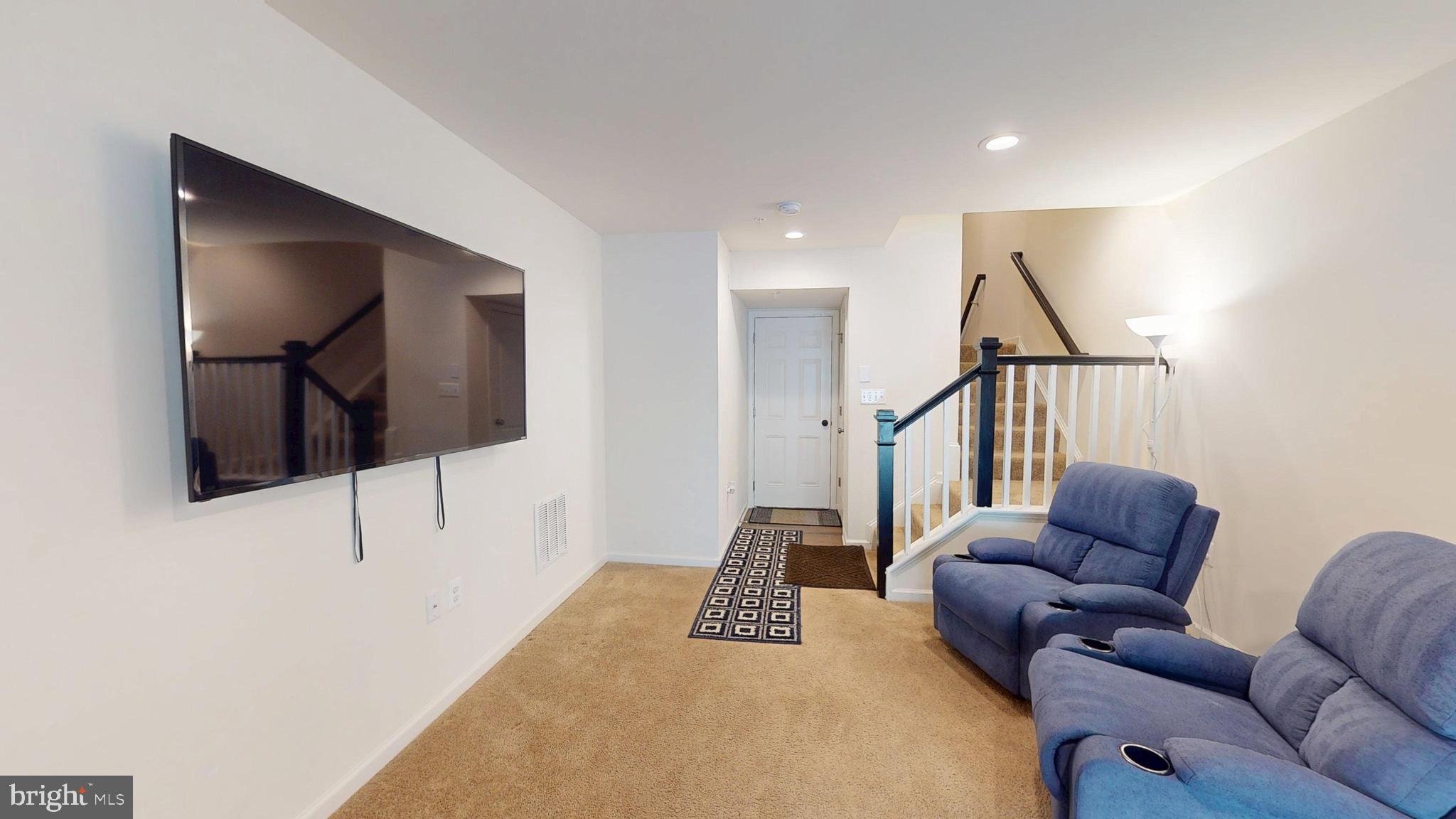 15103 Hogshead Way Upper Marlboro, MD 20772 - Photo 38 of 44 a living room with furniture and a flat screen tv