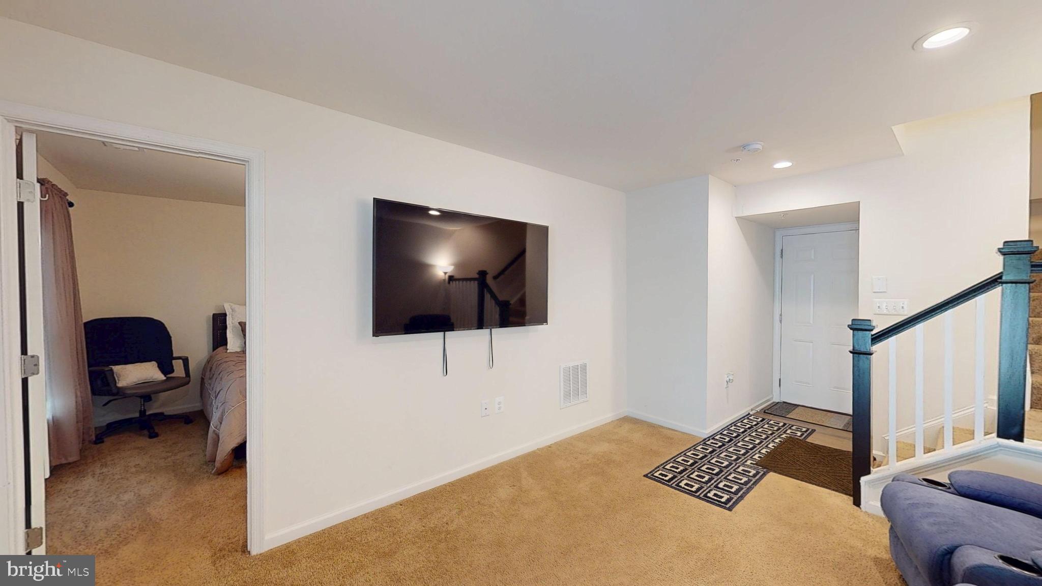 15103 Hogshead Way Upper Marlboro, MD 20772 - Photo 40 of 44 a living room with furniture and a flat screen tv