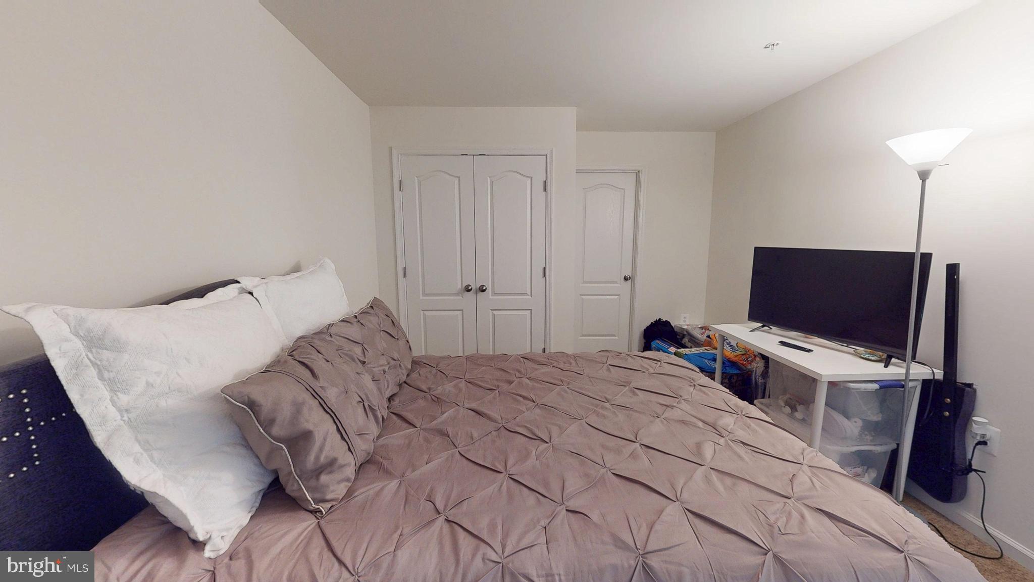 15103 Hogshead Way Upper Marlboro, MD 20772 - Photo 42 of 44 a bedroom with a bed and a flat screen tv
