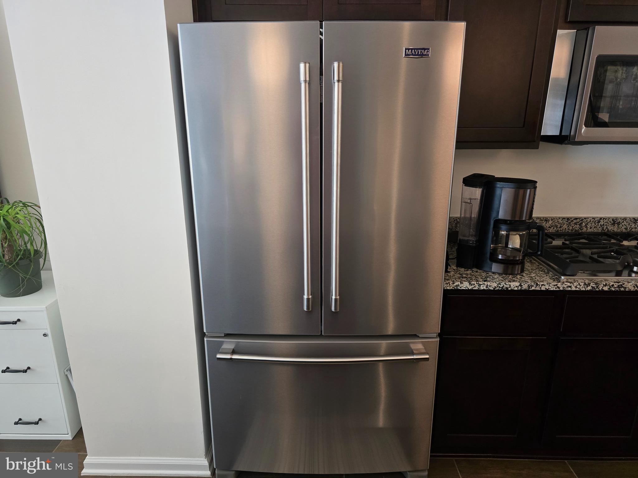 15103 Hogshead Way Upper Marlboro, MD 20772 - Photo 8 of 44 a view of a refrigerator in kitchen and an empty room