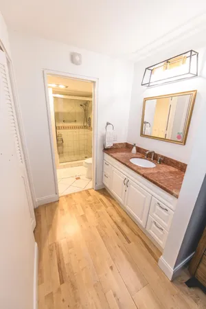 a living room with a large window couches and table chair