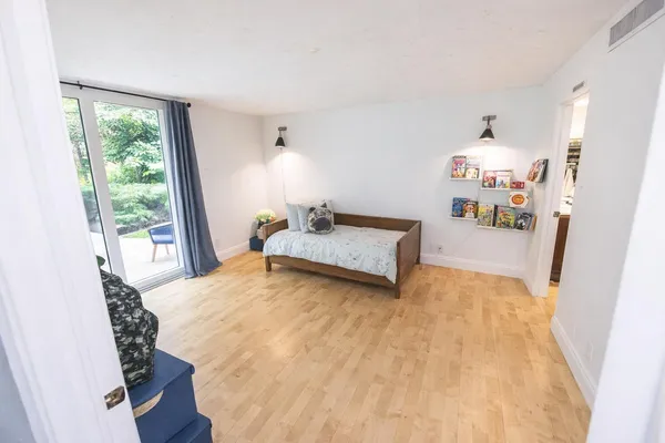 a living room with furniture and wooden floor