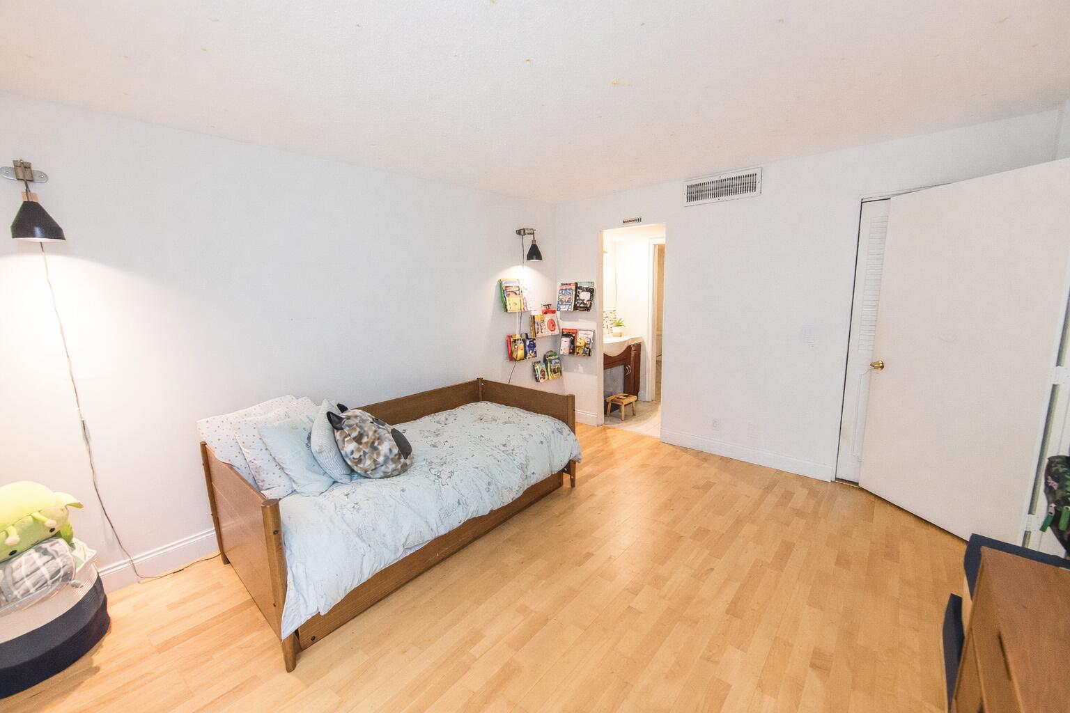 501 Southwest 11th Place, Unit 101 Boca Raton, FL 33432 - Photo 6 of 22 a living room with furniture and wooden floor