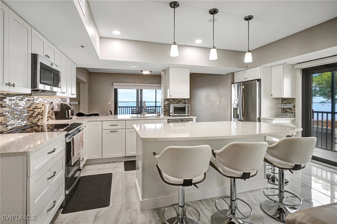 1900 Virginia Avenue, Unit 103 Fort Myers, FL 33901 - Photo 13 of 45 a kitchen with cabinets a center island and appliances