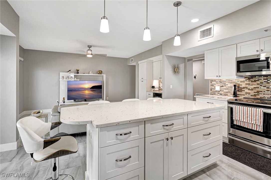1900 Virginia Avenue, Unit 103 Fort Myers, FL 33901 - Photo 16 of 45 a kitchen with cabinets stainless steel appliances and a counter top space