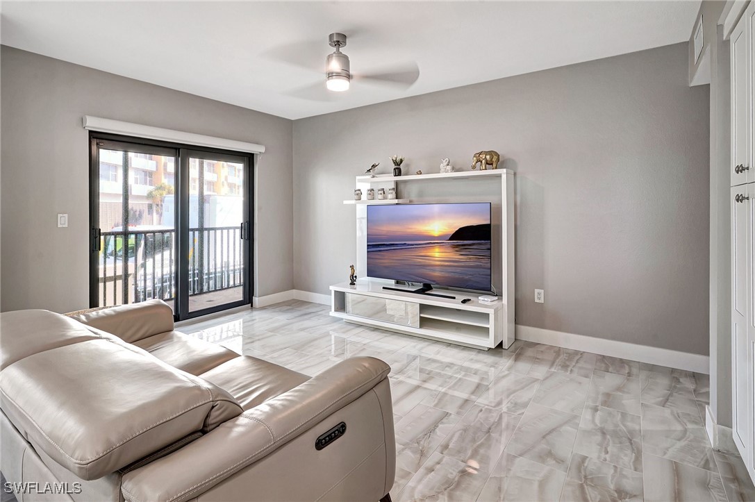1900 Virginia Avenue, Unit 103 Fort Myers, FL 33901 - Photo 17 of 45 a living room with furniture and a flat screen tv