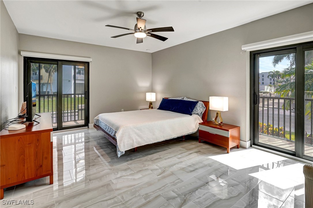 1900 Virginia Avenue, Unit 103 Fort Myers, FL 33901 - Photo 28 of 45 a bedroom with a bed and a large window