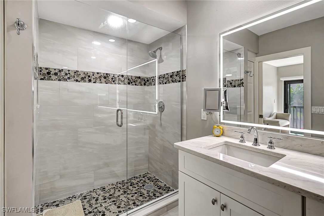 1900 Virginia Avenue, Unit 103 Fort Myers, FL 33901 - Photo 29 of 45 a bathroom with a sink shower and a mirror