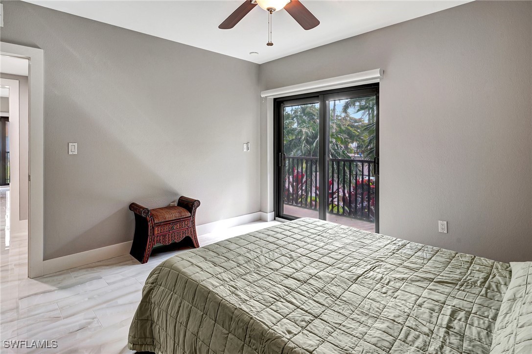 1900 Virginia Avenue, Unit 103 Fort Myers, FL 33901 - Photo 35 of 45 a bedroom with a bed and a chandelier