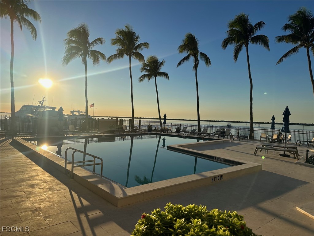 1900 Virginia Avenue, Unit 103 Fort Myers, FL 33901 - Photo 40 of 45 a view of a swimming pool with a table and chairs