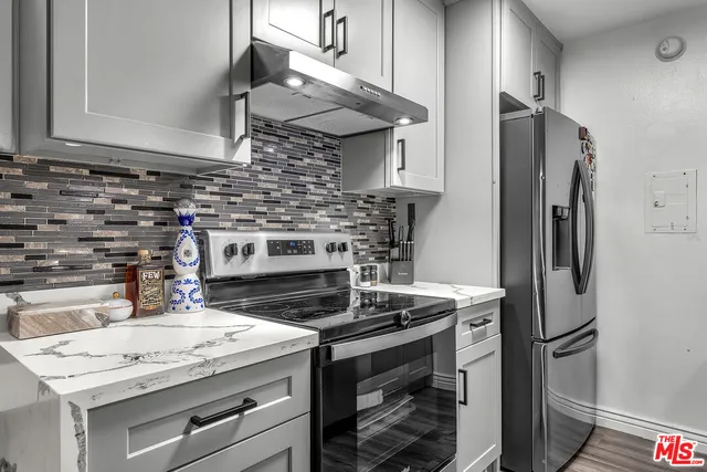 a living room with furniture a flat screen tv and wooden floor