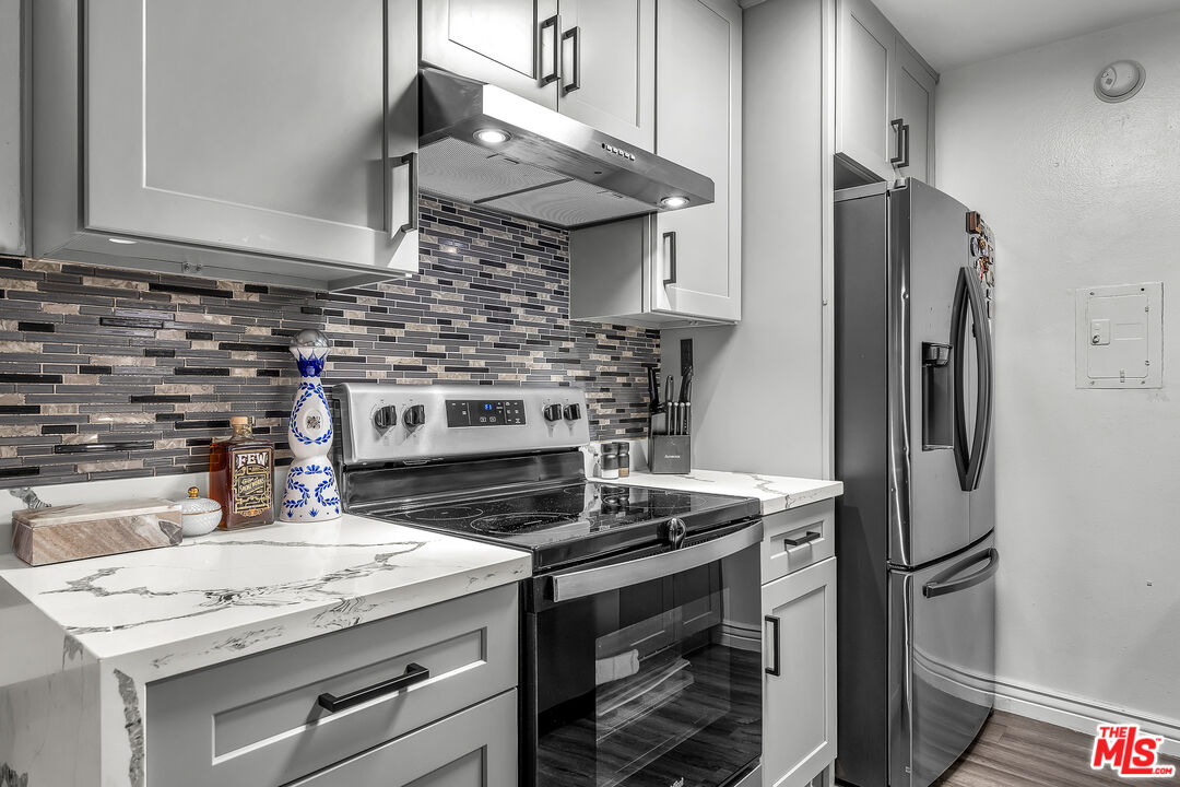 5460 White Oak Avenue, Unit D309 Encino, CA 91316 - Photo 13 of 22 a kitchen with stainless steel appliances granite countertop a sink stove and refrigerator
