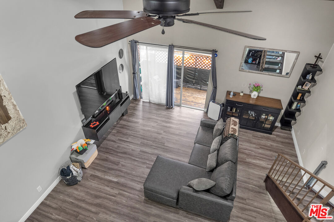 5460 White Oak Avenue, Unit D309 Encino, CA 91316 - Photo 14 of 22 a living room with furniture a flat screen tv and wooden floor