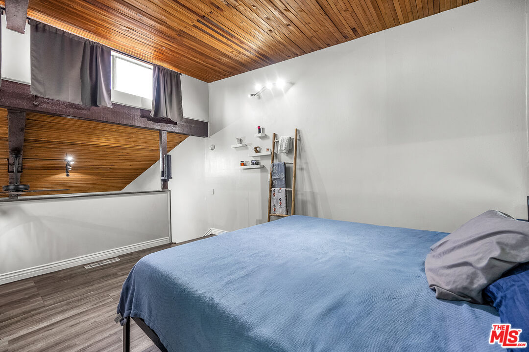 5460 White Oak Avenue, Unit D309 Encino, CA 91316 - Photo 15 of 22 a bed room with a bed and a refrigerator