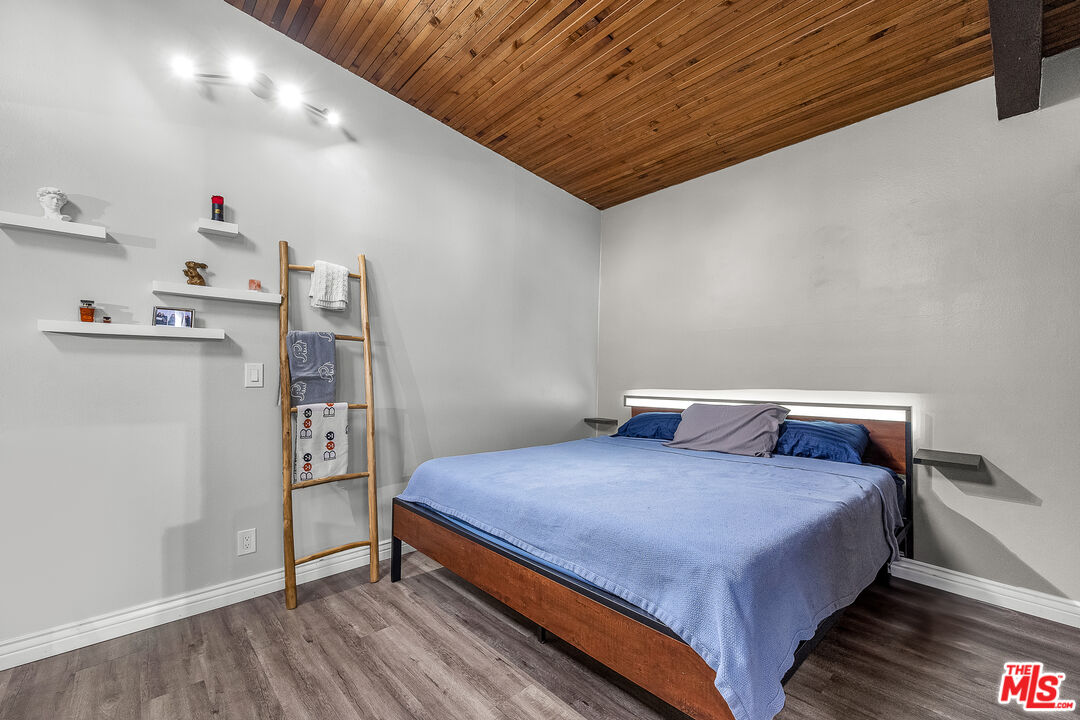 5460 White Oak Avenue, Unit D309 Encino, CA 91316 - Photo 16 of 22 a bedroom with a bed and cabinets