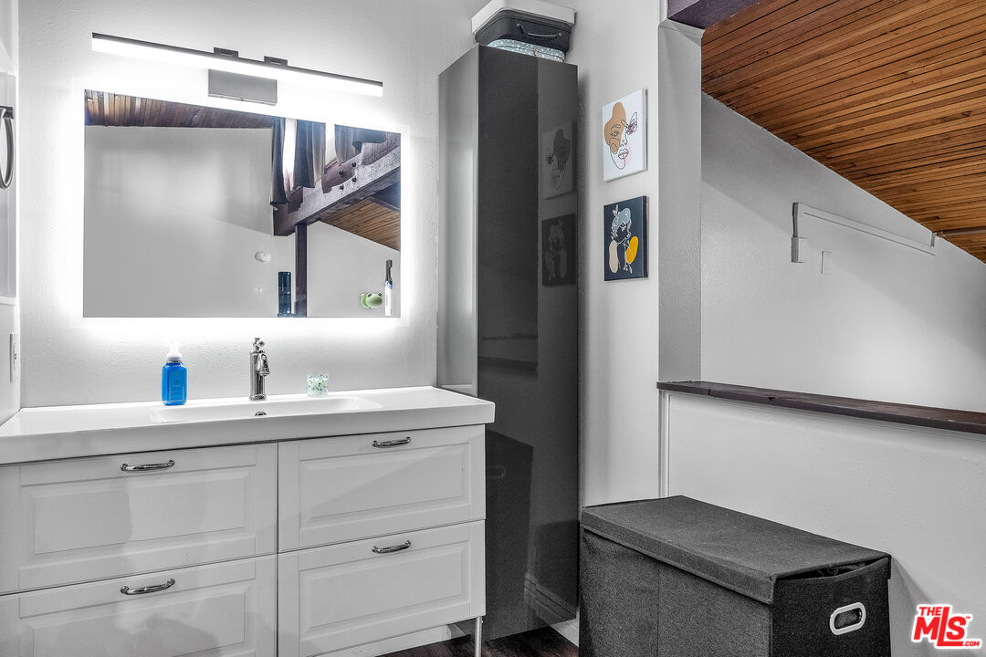 5460 White Oak Avenue, Unit D309 Encino, CA 91316 - Photo 17 of 22 a bathroom with a sink and a mirror