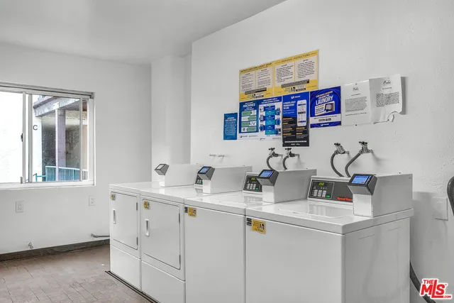 a view of a big building with a big yard and large trees