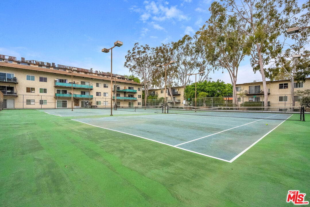 5460 White Oak Avenue, Unit D309 Encino, CA 91316 - Photo 20 of 22 a view of a big building with a big yard and large trees