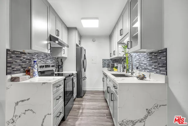 a kitchen with a sink stove and refrigerator