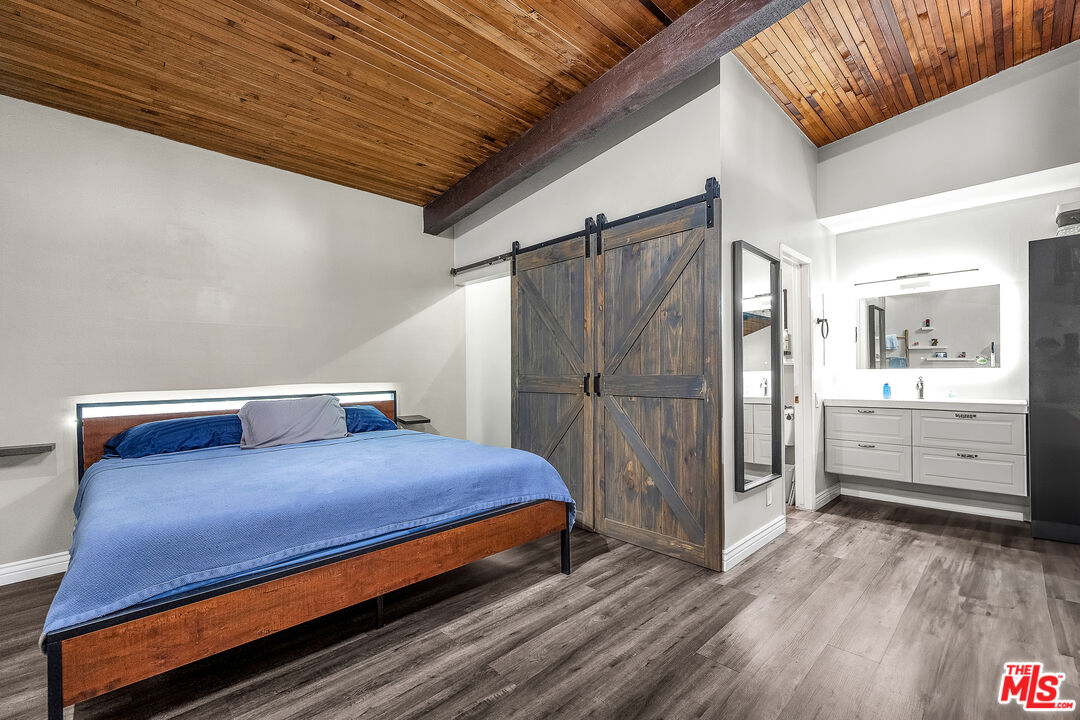 5460 White Oak Avenue, Unit D309 Encino, CA 91316 - Photo 6 of 22 a bedroom with a bed and a view of bedroom