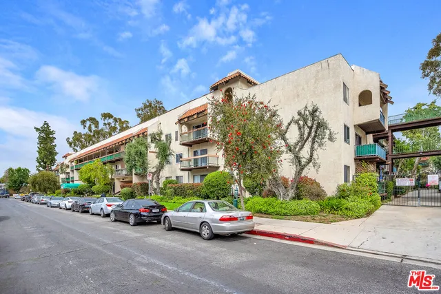 a car parked in front of a house with a street