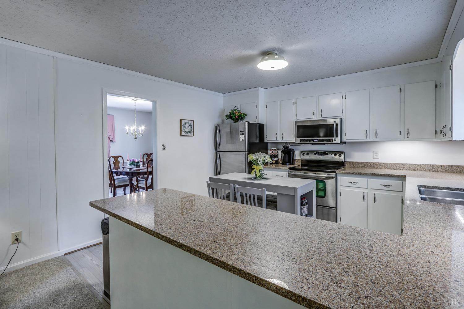 759 Farfields Drive Lynchburg, VA 24502 - Photo 15 of 53 a kitchen with kitchen island a sink counter top space appliances and cabinets