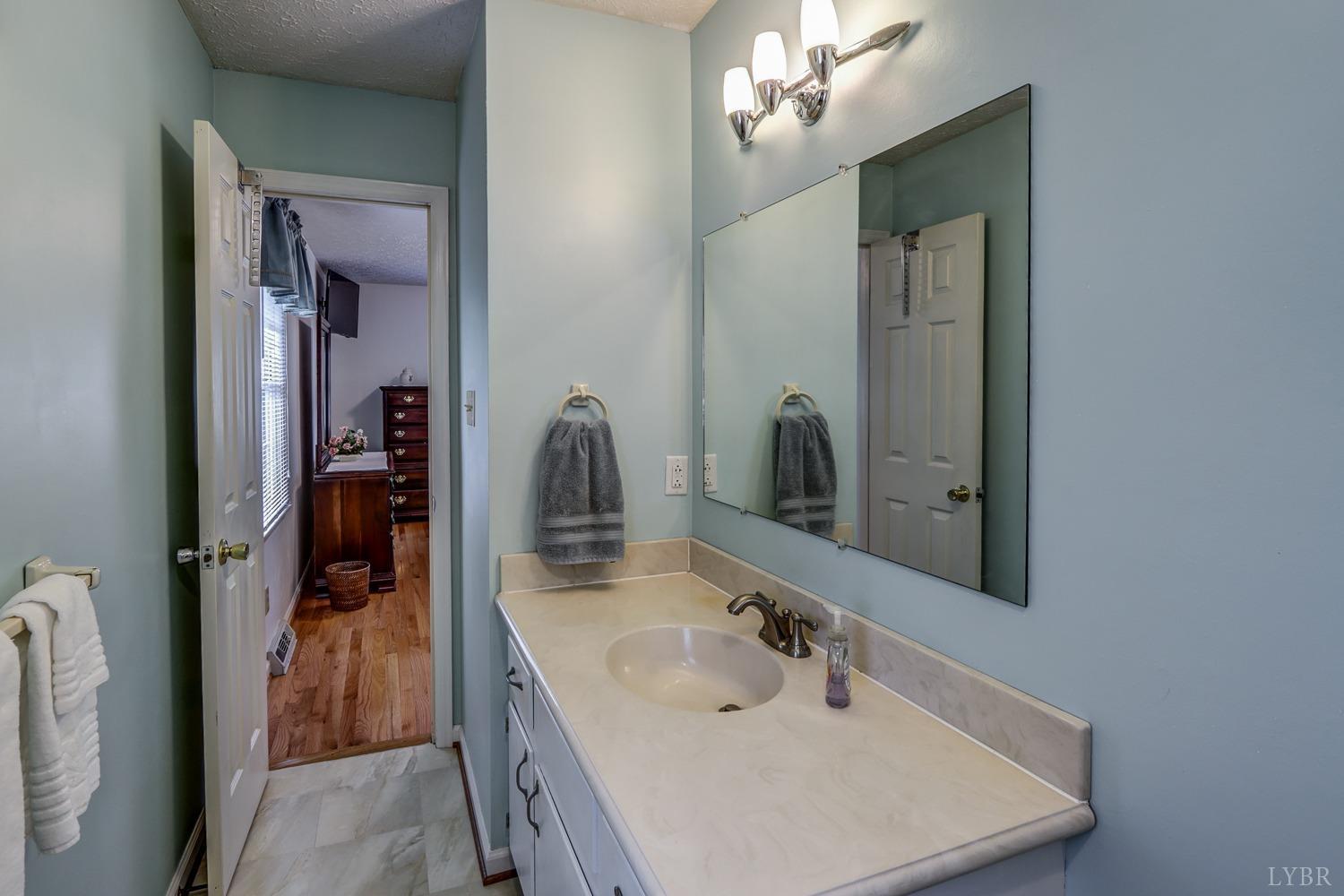 759 Farfields Drive Lynchburg, VA 24502 - Photo 28 of 53 a bathroom with a sink a vanity and a mirror