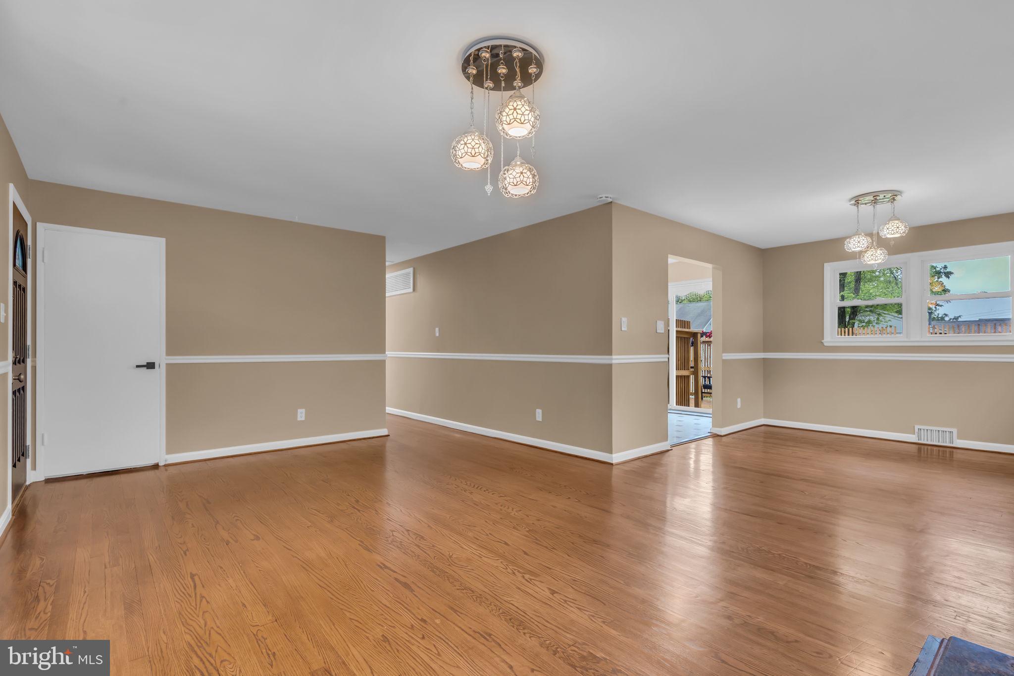 6809 Braddock Road Springfield, VA 22151 - Photo 13 of 60 an empty room with wooden floor mirror and windows