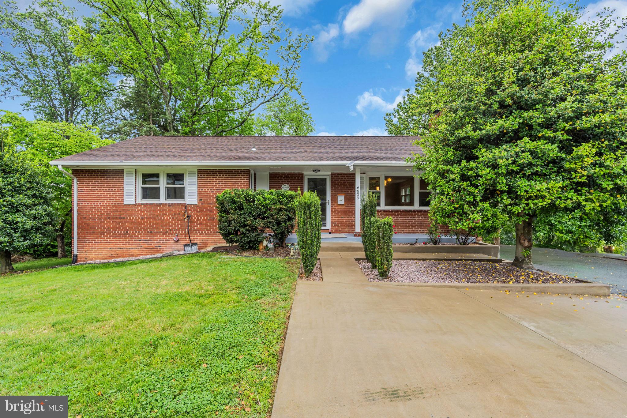 6809 Braddock Road Springfield, VA 22151 - Photo 2 of 60 front view of a house with a yard