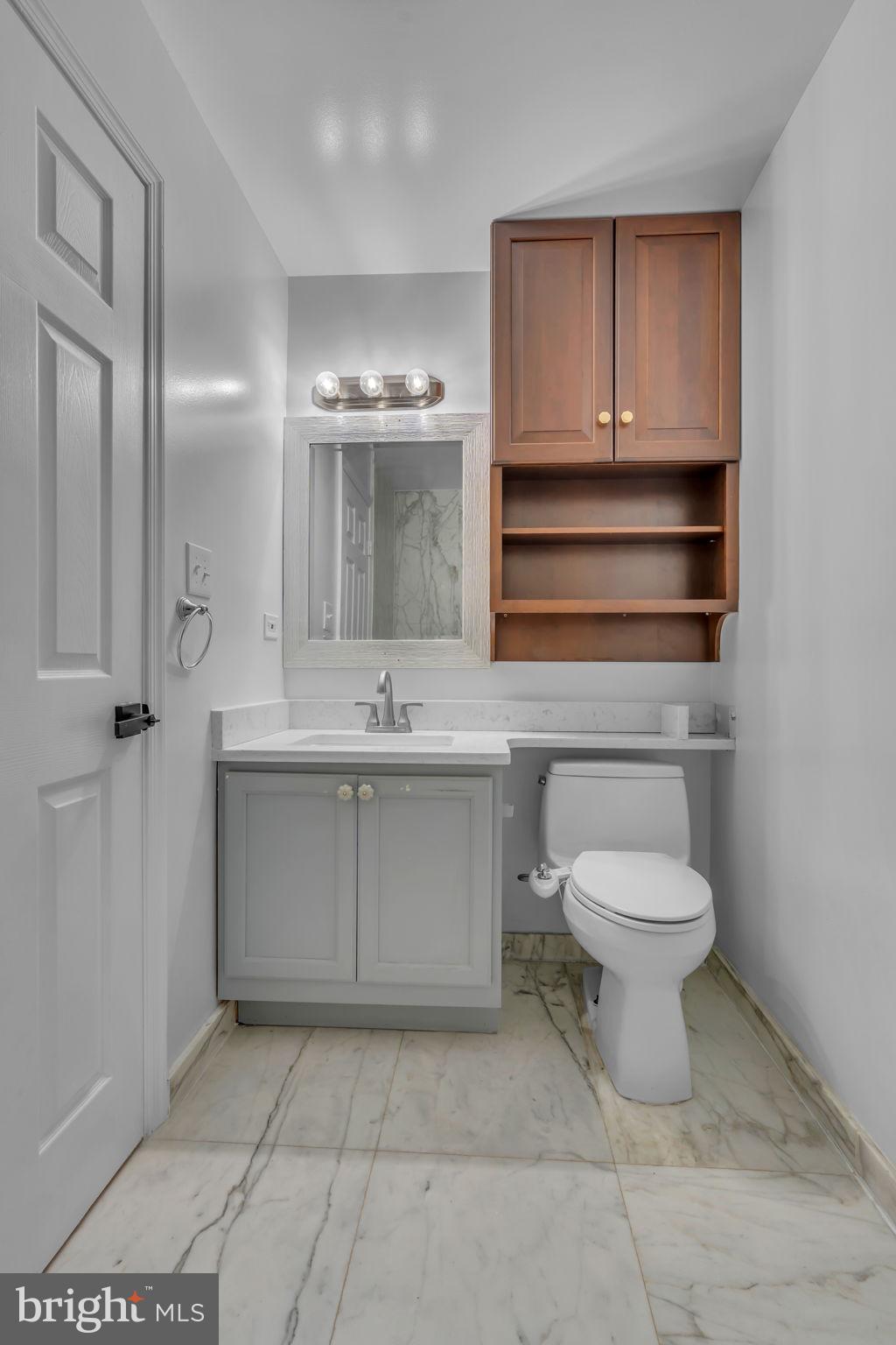 6809 Braddock Road Springfield, VA 22151 - Photo 21 of 60 a bathroom with a sink toilet and shower