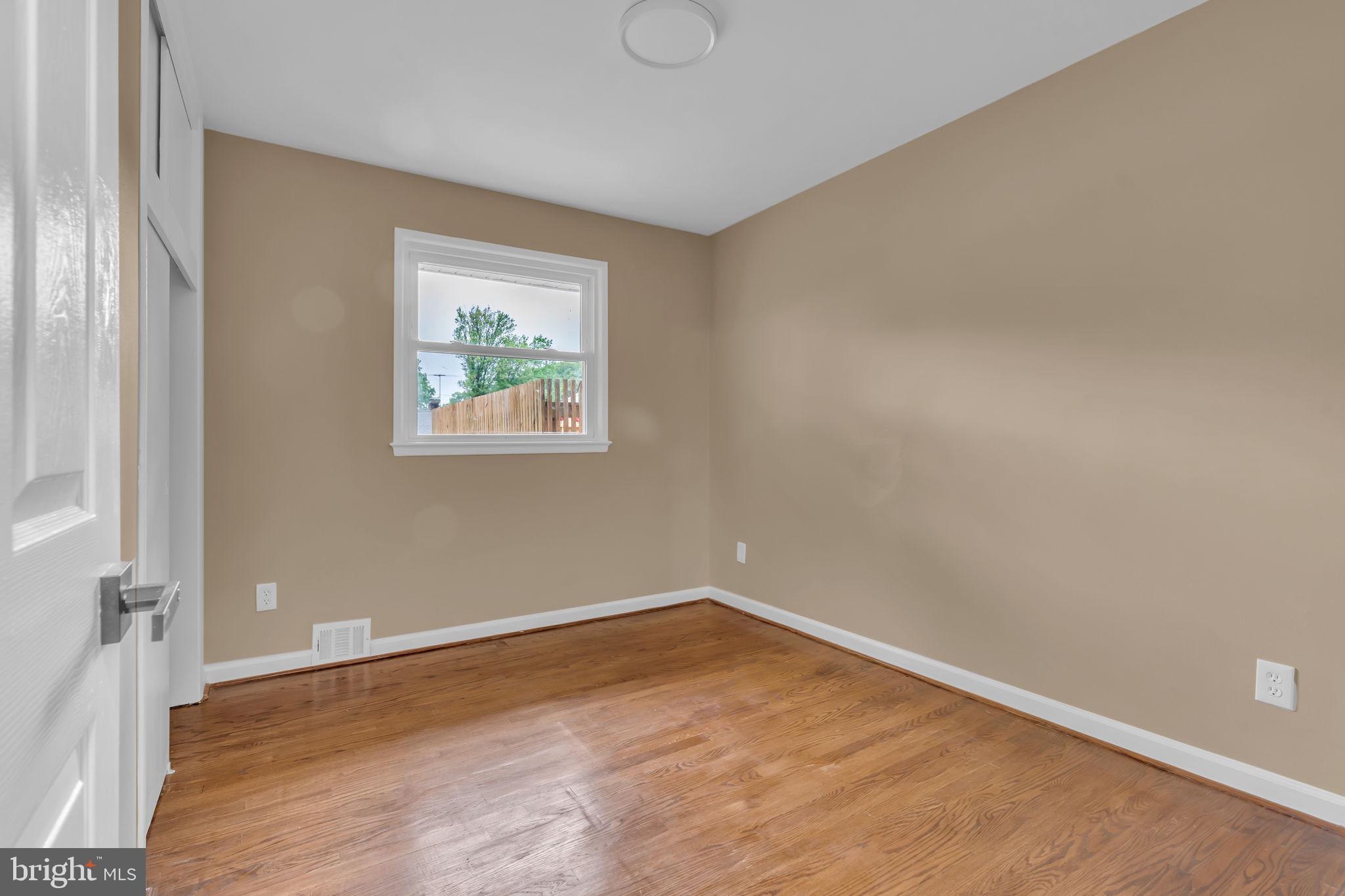 6809 Braddock Road Springfield, VA 22151 - Photo 22 of 60 an empty room with wooden floor and windows