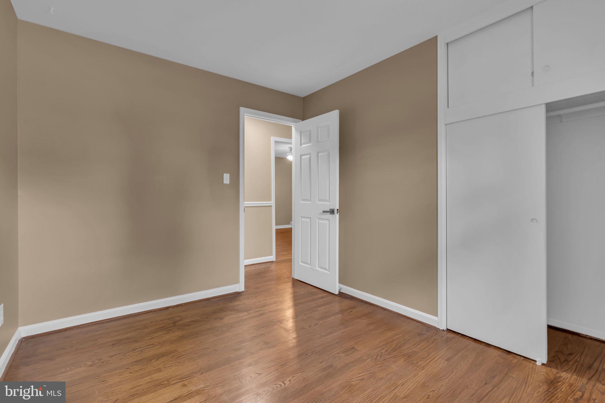 6809 Braddock Road Springfield, VA 22151 - Photo 23 of 60 a view of an empty room with wooden floor