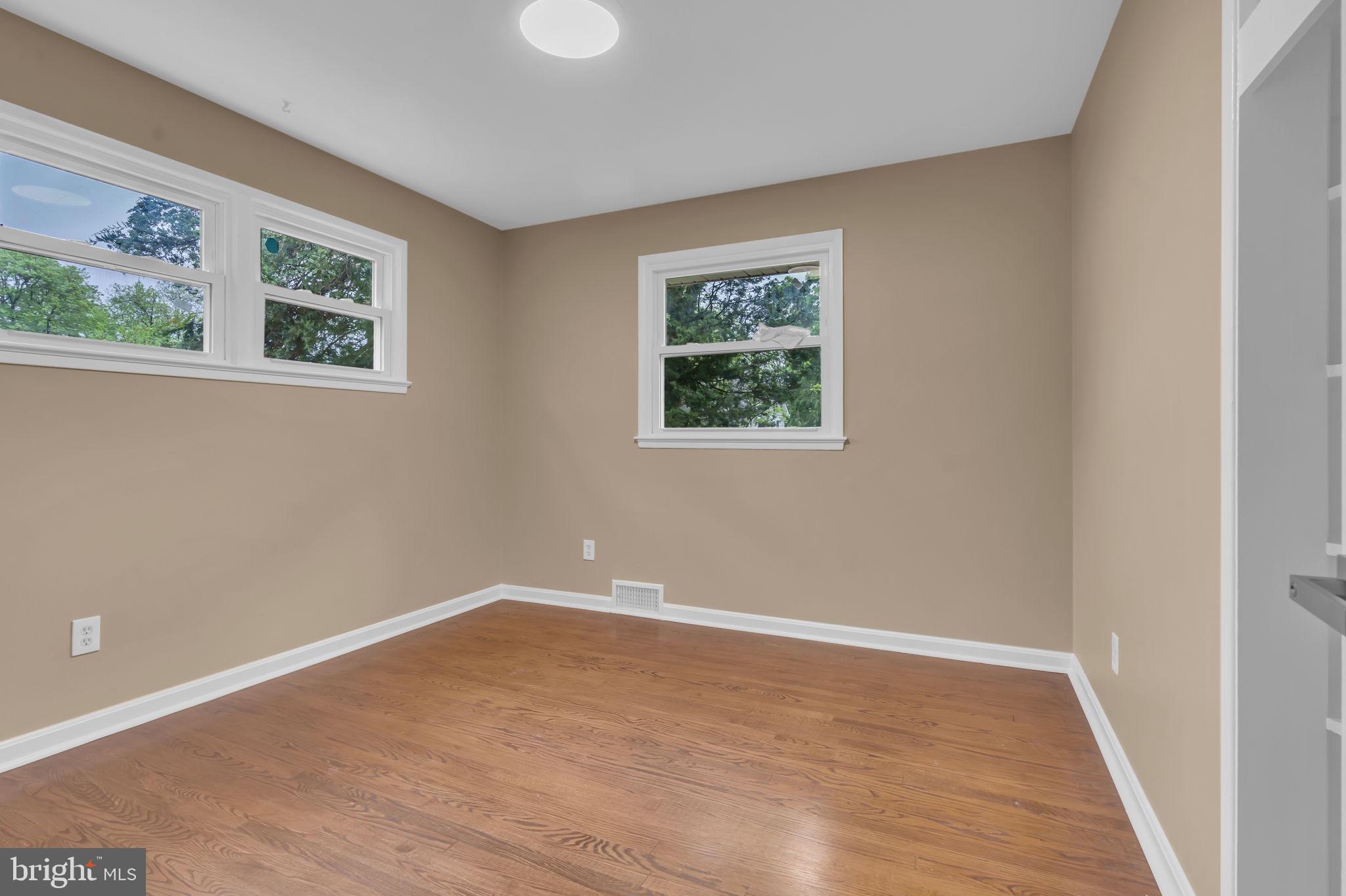6809 Braddock Road Springfield, VA 22151 - Photo 24 of 60 a view of an empty room with wooden floor and a window