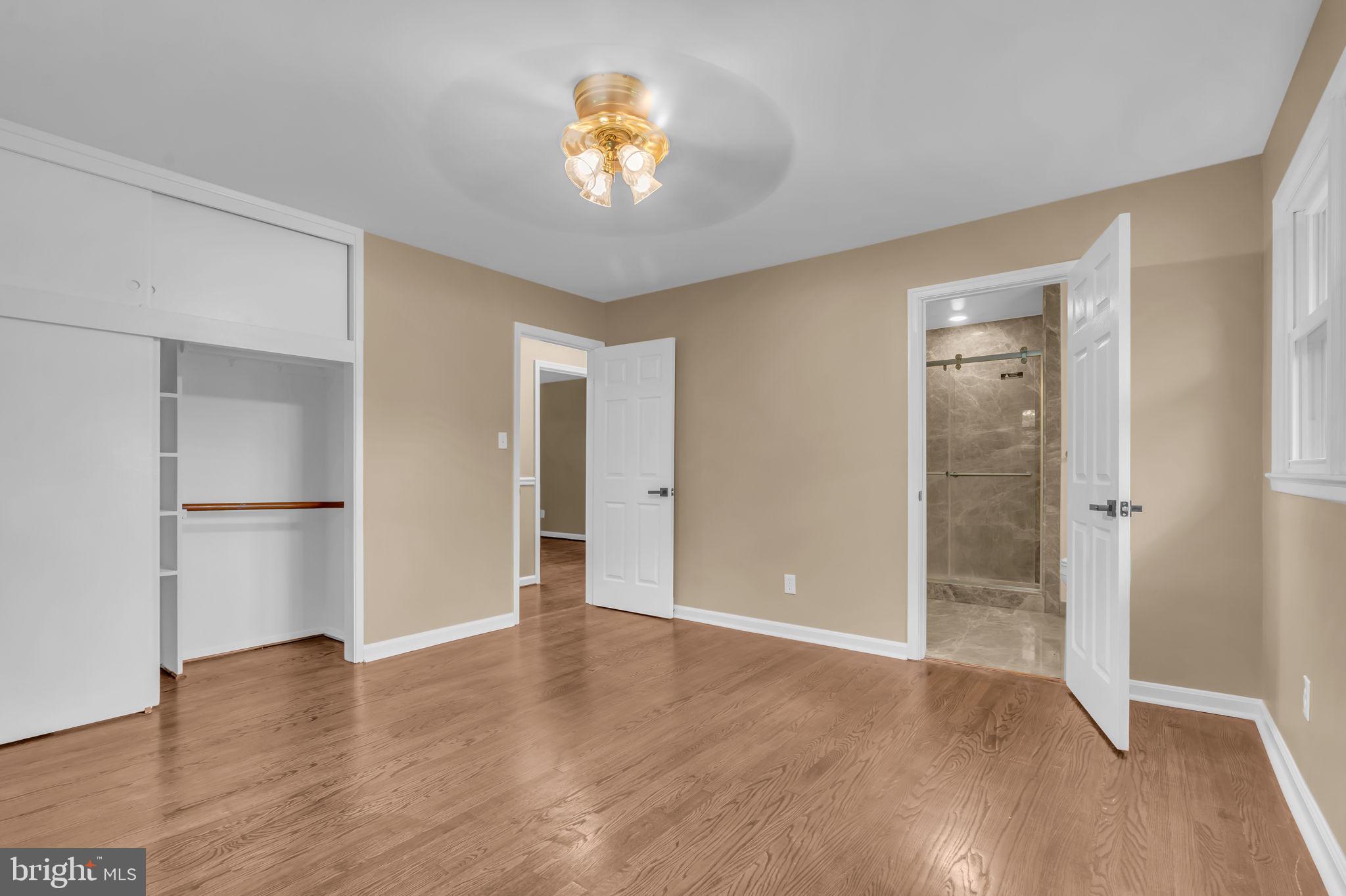 6809 Braddock Road Springfield, VA 22151 - Photo 27 of 60 wooden floor in an empty room with a window