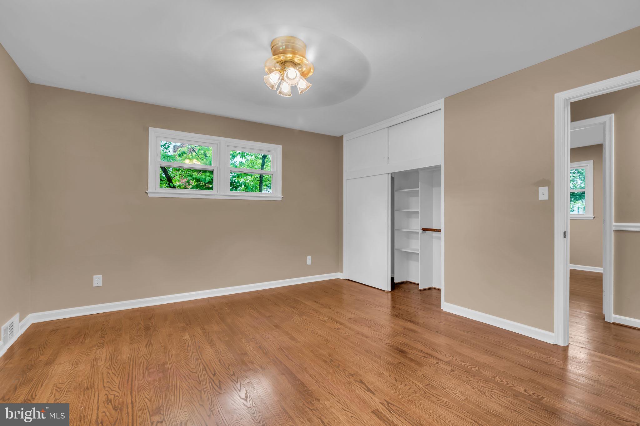 6809 Braddock Road Springfield, VA 22151 - Photo 28 of 60 wooden floor in an empty room with a window