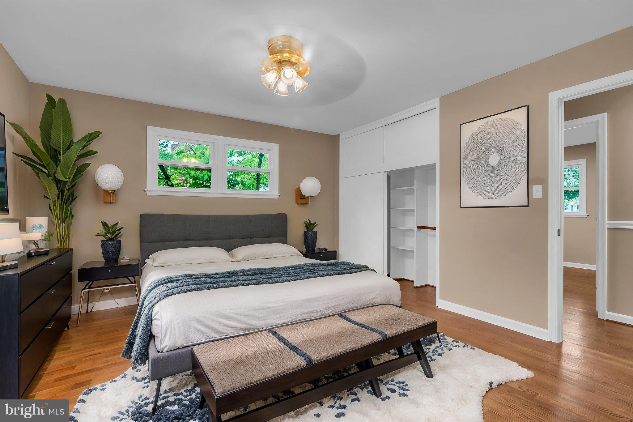 6809 Braddock Road Springfield, VA 22151 - Photo 29 of 60 a bedroom with a bed and a chandelier