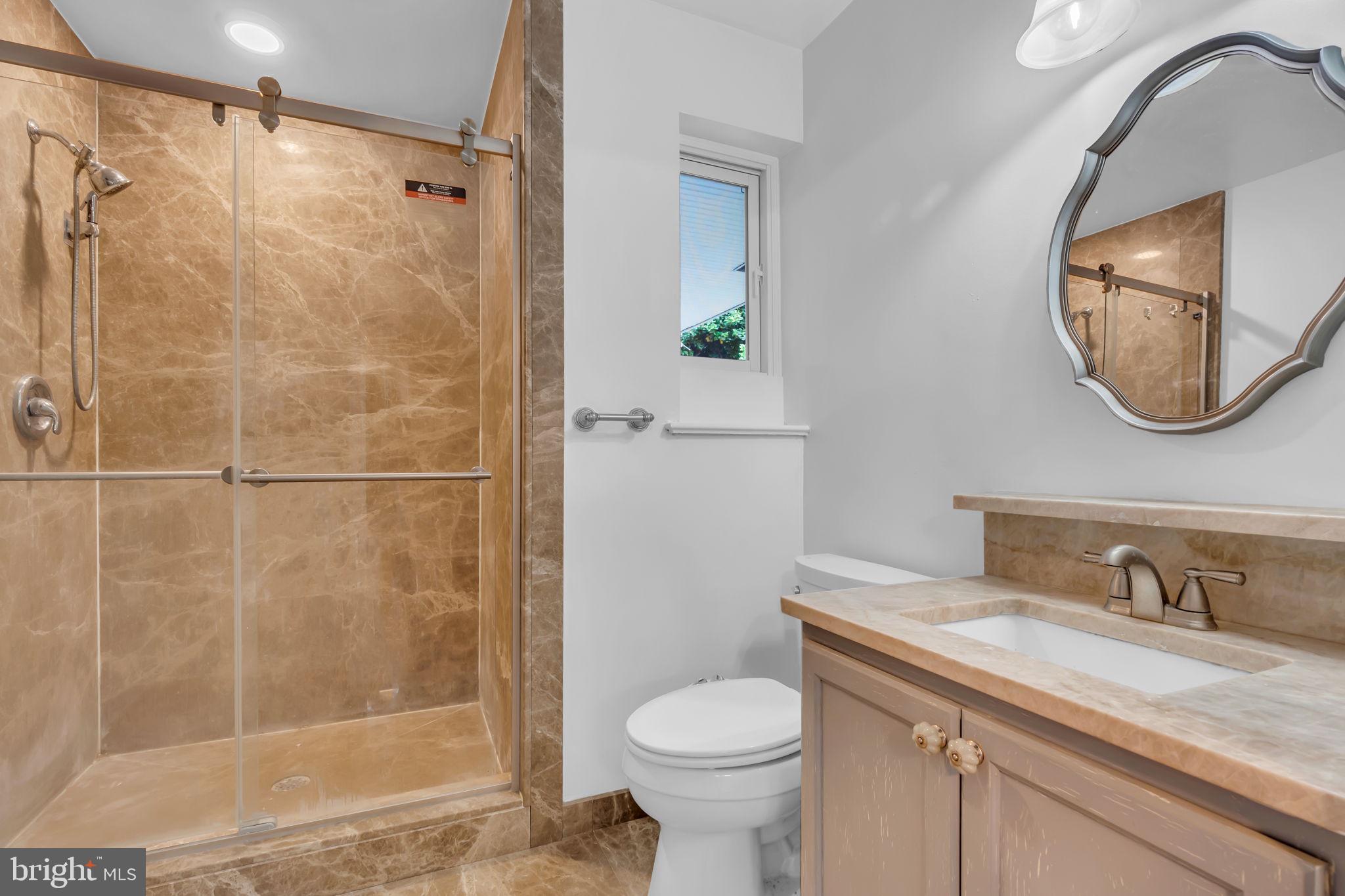 6809 Braddock Road Springfield, VA 22151 - Photo 30 of 60 a bathroom with a sink toilet and shower