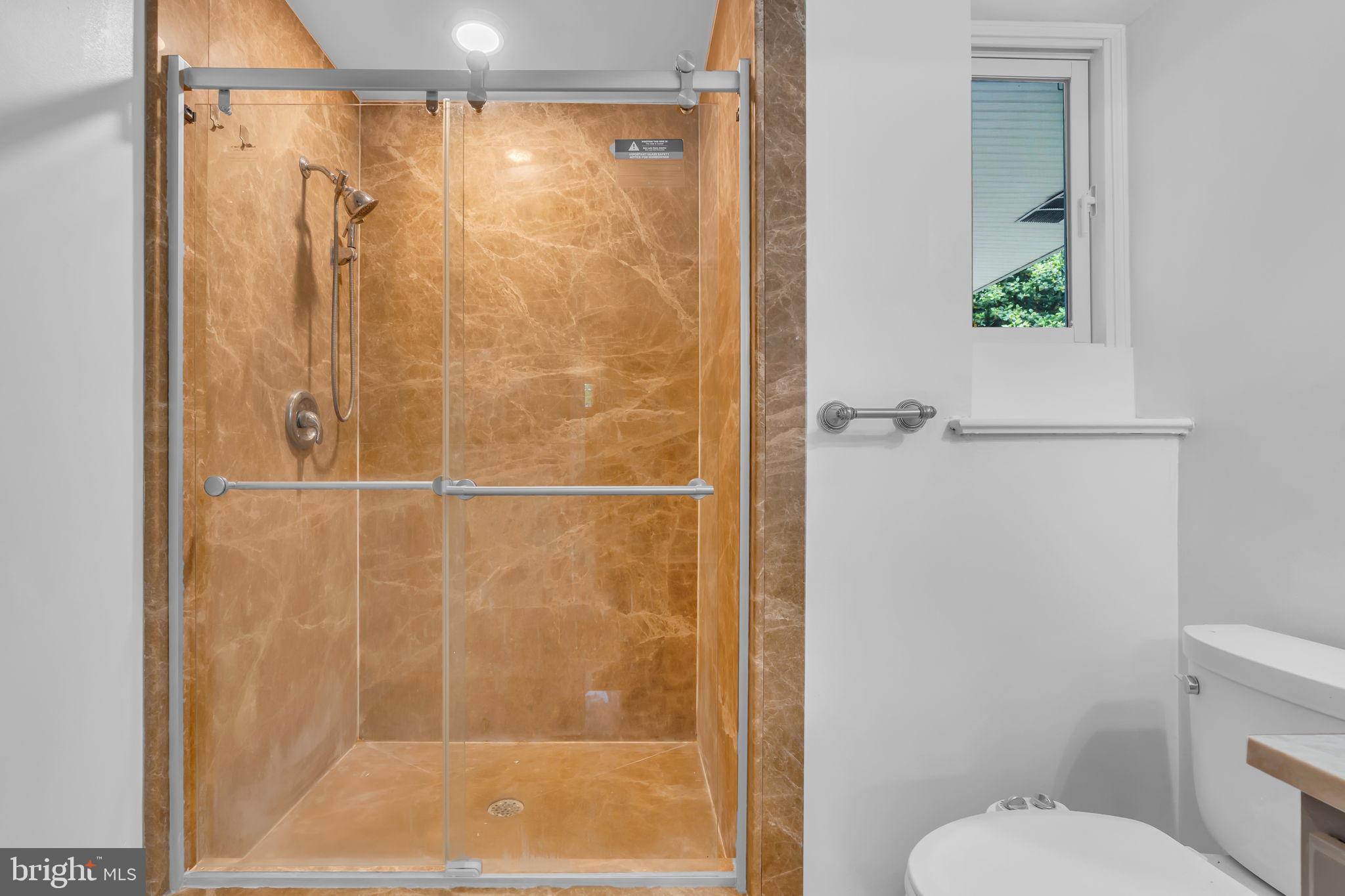 6809 Braddock Road Springfield, VA 22151 - Photo 31 of 60 a bathroom with a shower and toilet