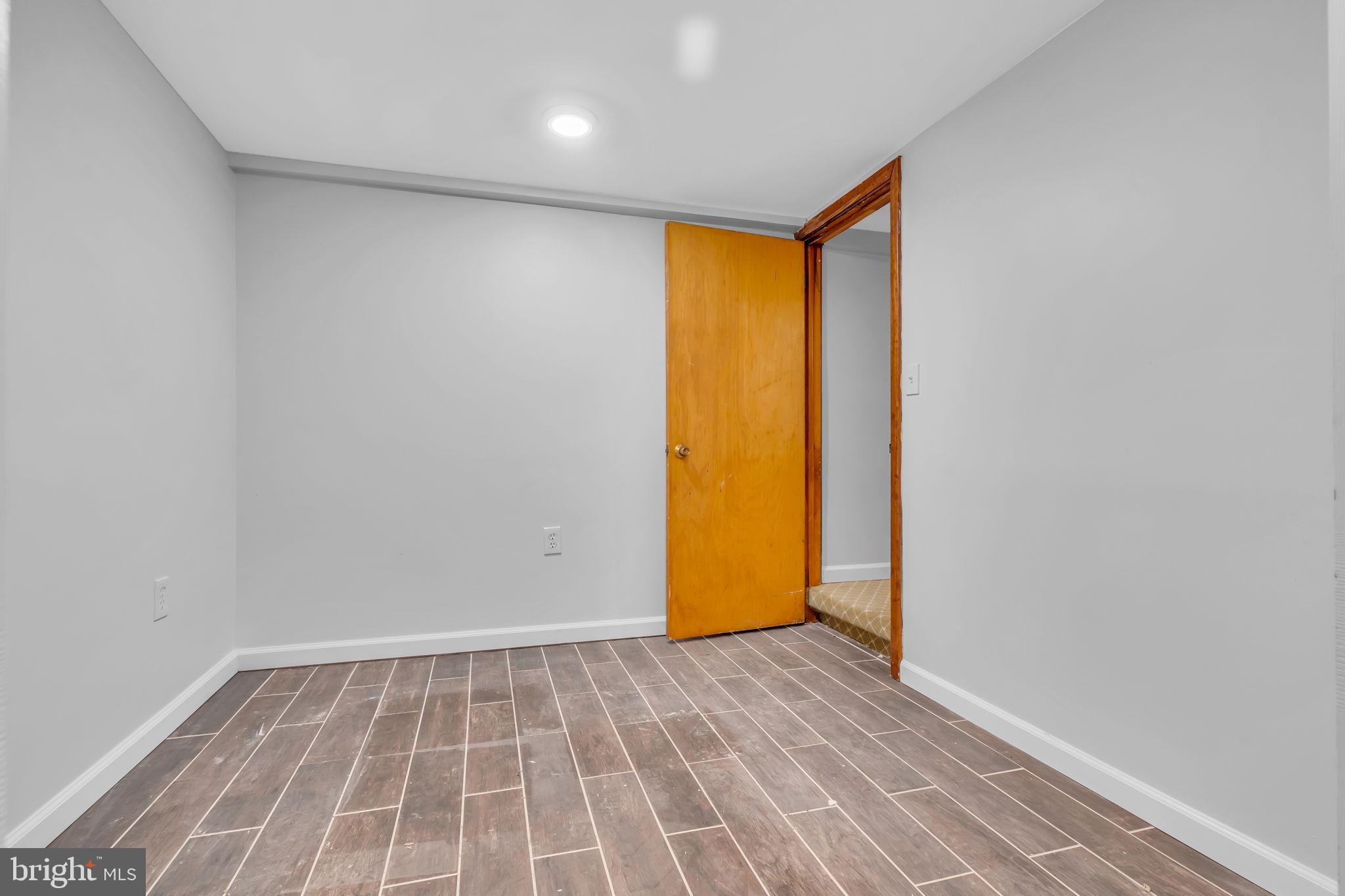 6809 Braddock Road Springfield, VA 22151 - Photo 34 of 60 a view of an empty room with wooden floor and a window