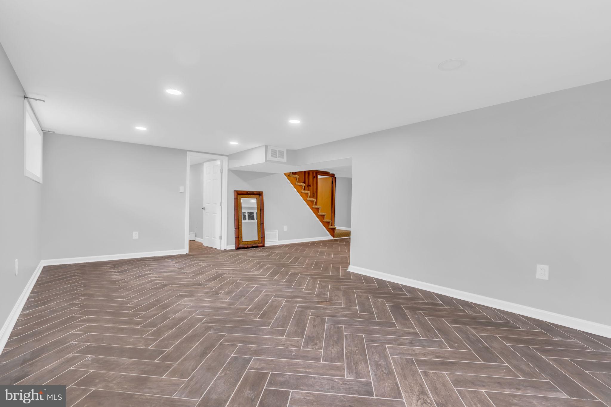 6809 Braddock Road Springfield, VA 22151 - Photo 40 of 60 a view of an empty room with window and wooden floor