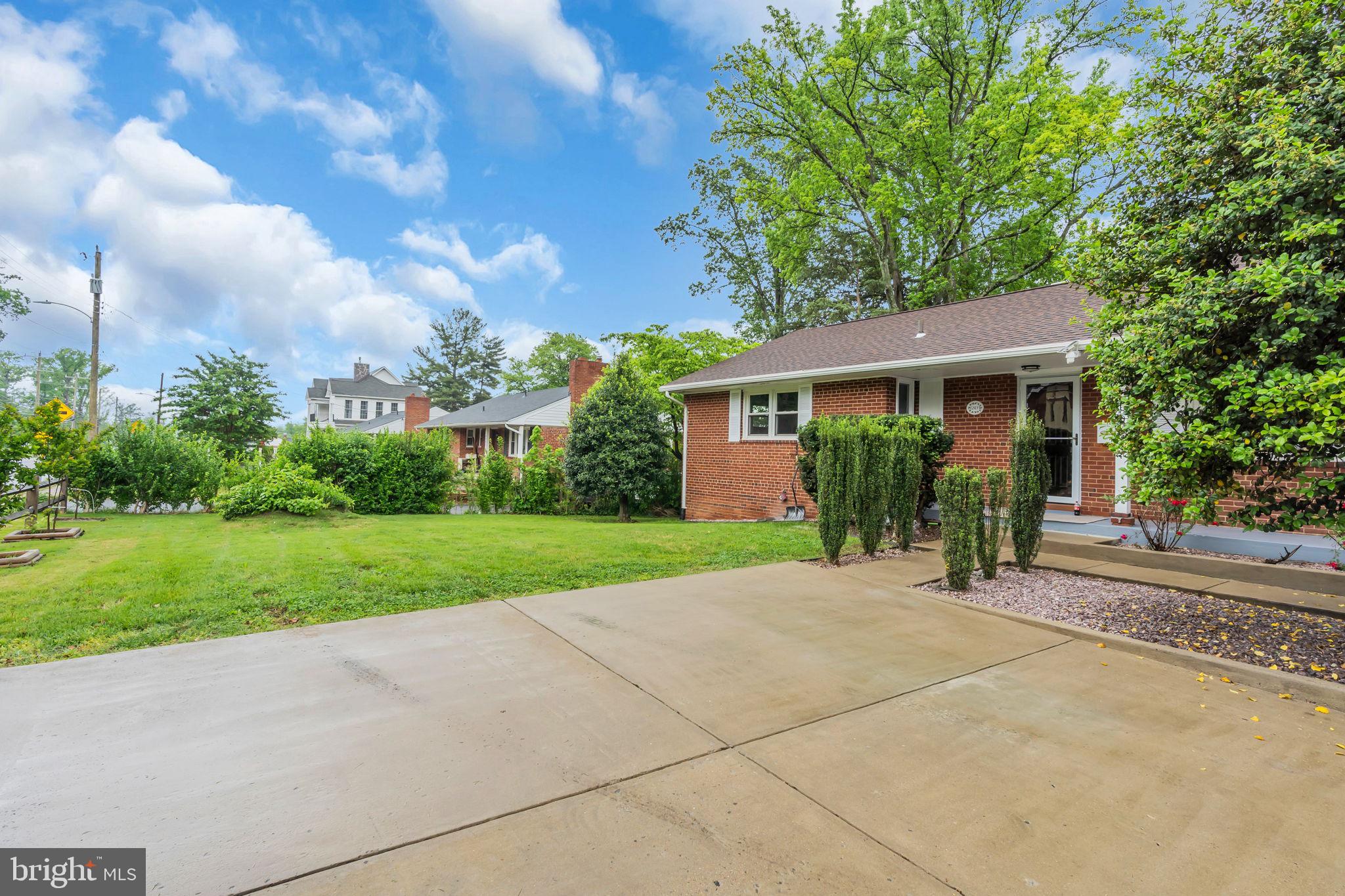 6809 Braddock Road Springfield, VA 22151 - Photo 4 of 60 a view of a house with yard and a garden