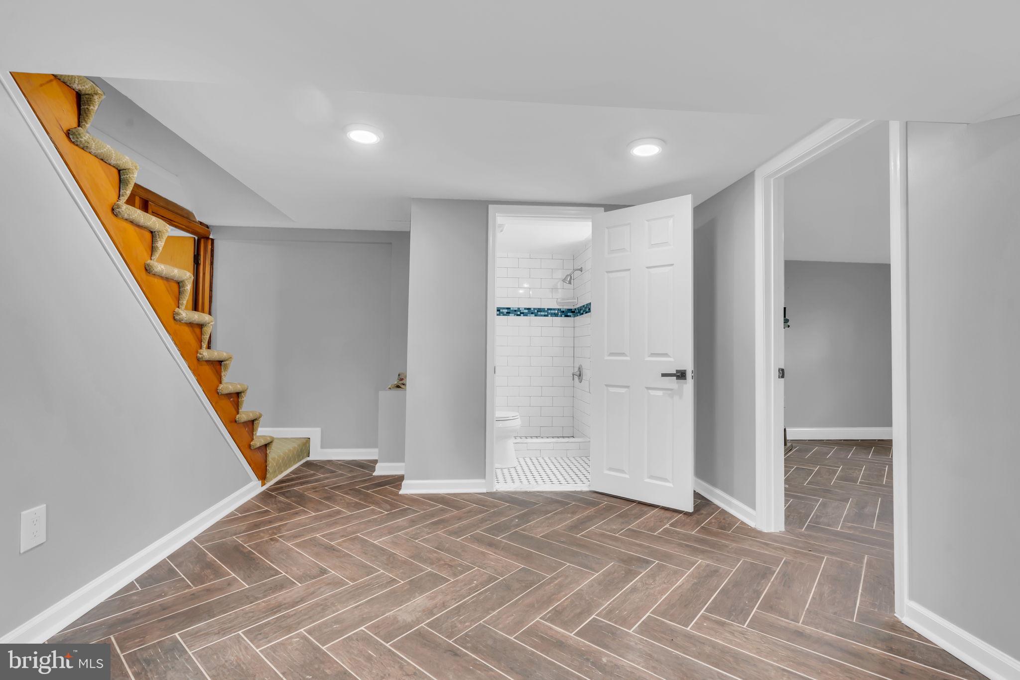 6809 Braddock Road Springfield, VA 22151 - Photo 43 of 60 a view of a hallway with wooden floor and staircase