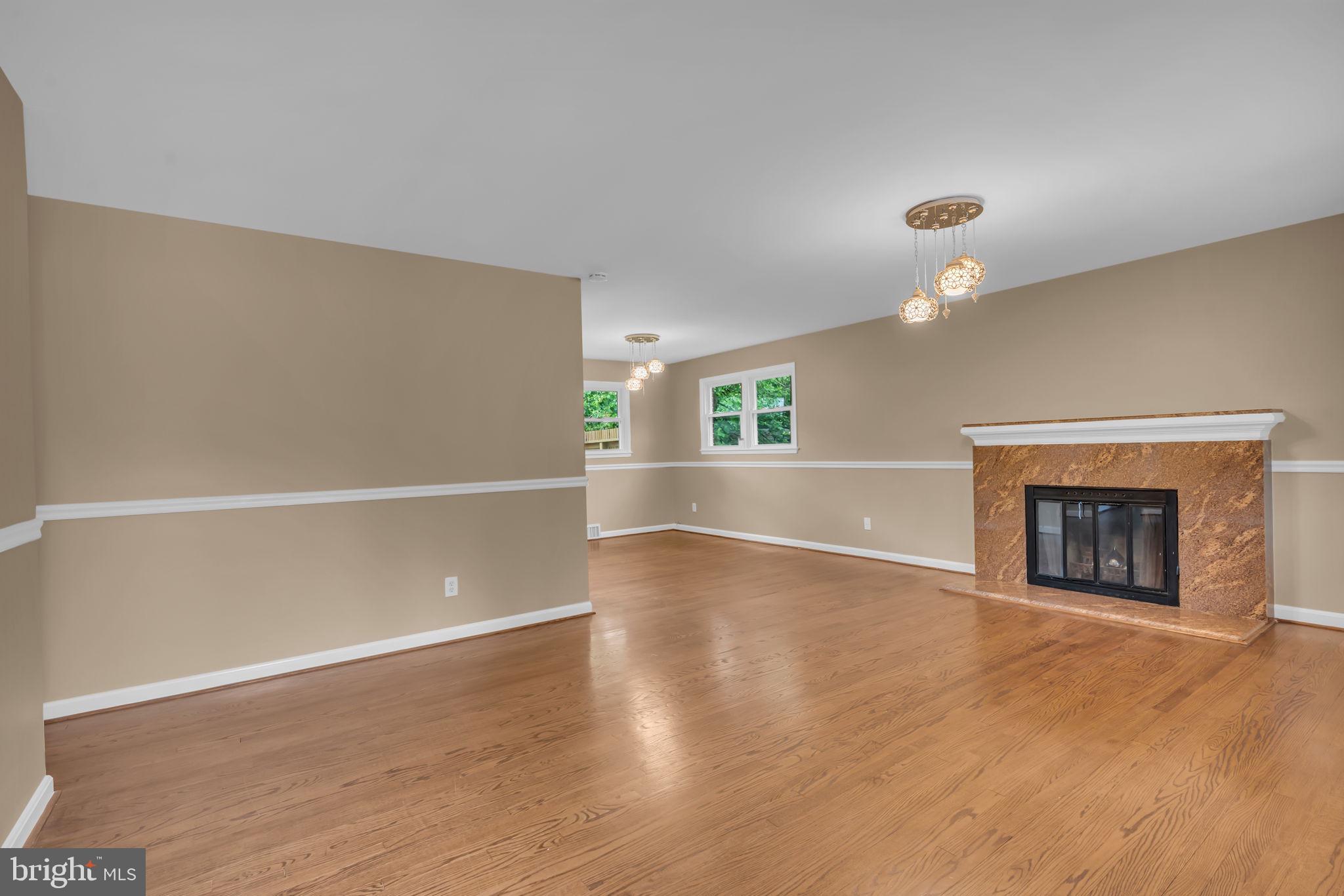 6809 Braddock Road Springfield, VA 22151 - Photo 7 of 60 an empty room with wooden floor and fireplace