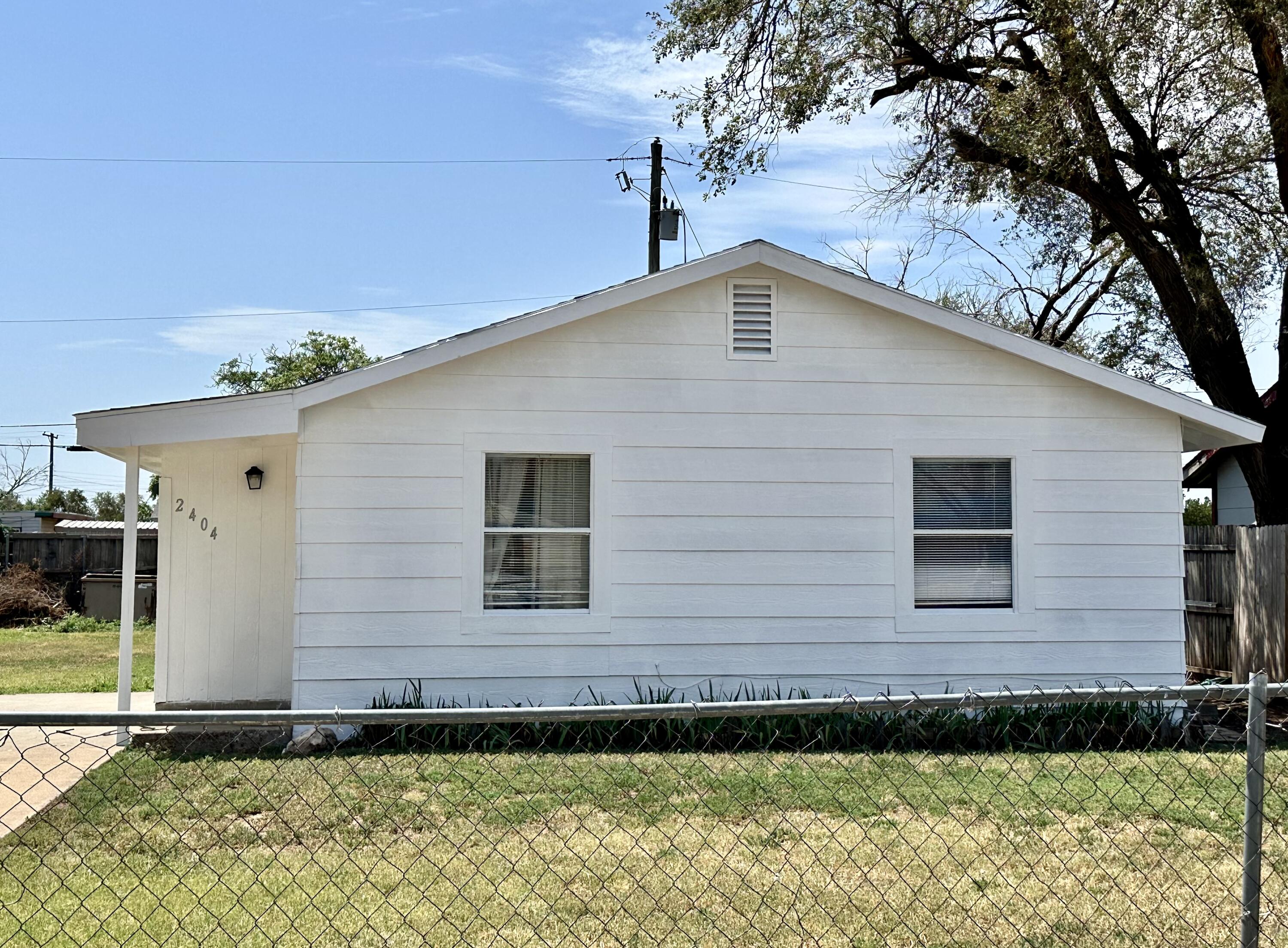 2404 East 5th Street Lubbock, TX 79403 - Photo 14 of 14 a backyard of a house with lots of green space