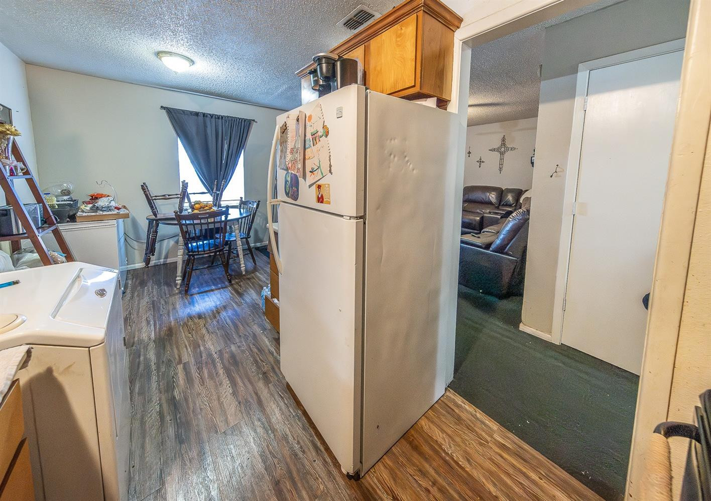 2404 East 5th Street Lubbock, TX 79403 - Photo 7 of 14 a view of a hallway with wooden floor and furniture