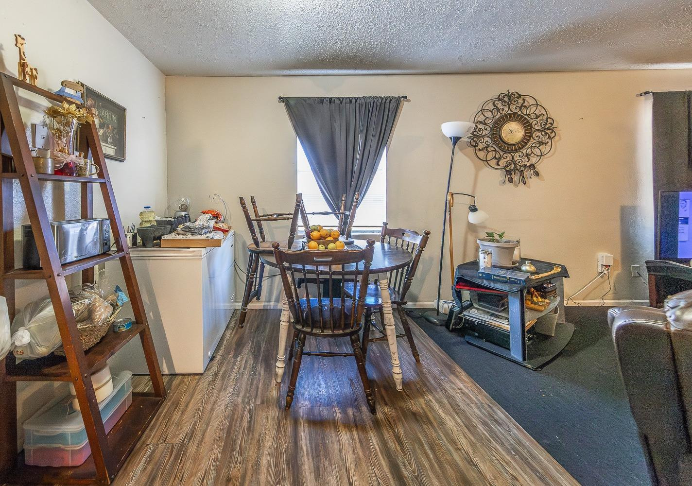 2404 East 5th Street Lubbock, TX 79403 - Photo 8 of 14 a dining room with furniture wooden floor a rug and a chandelier