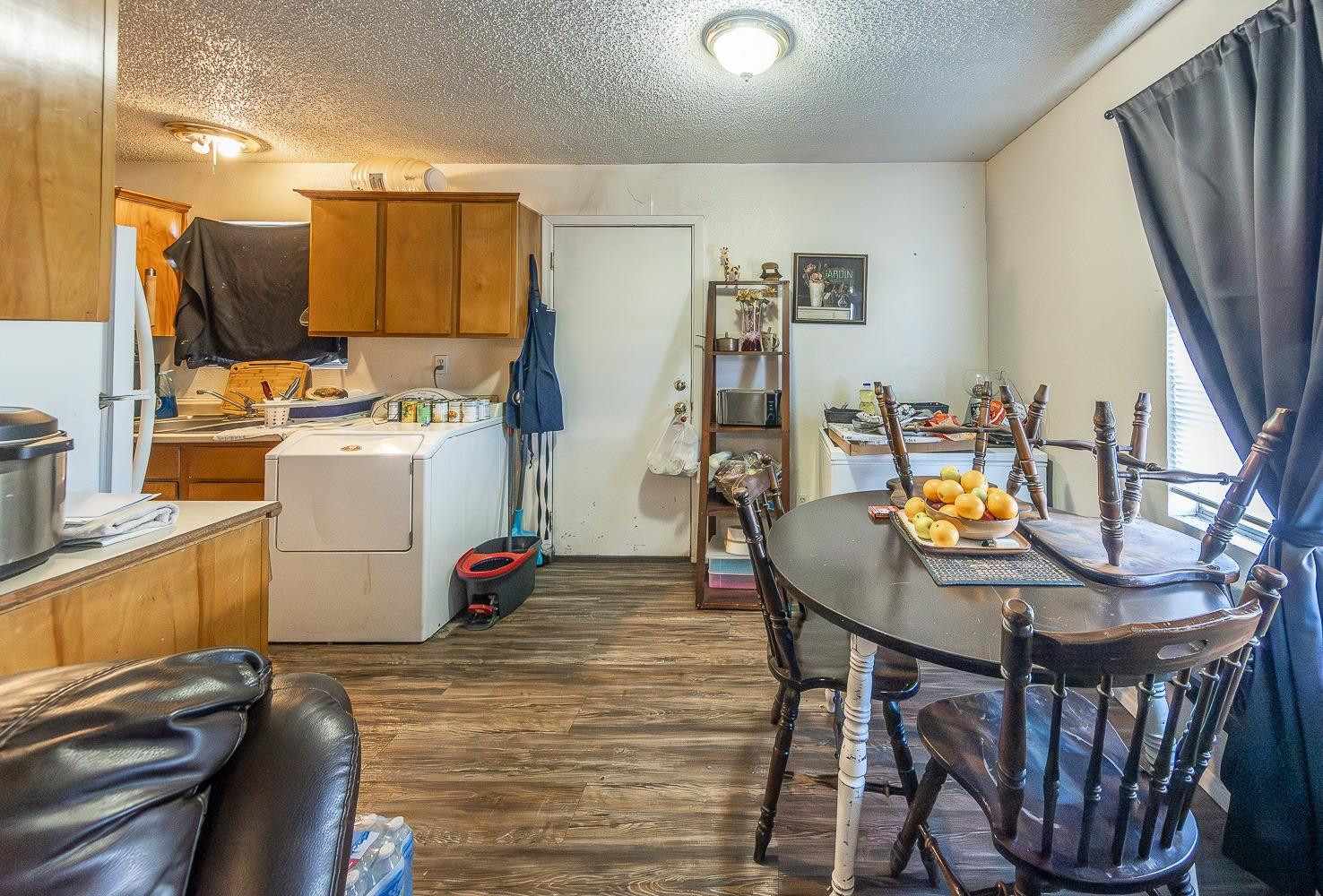 2404 East 5th Street Lubbock, TX 79403 - Photo 9 of 14 a view of a kitchen with furniture and wooden floor
