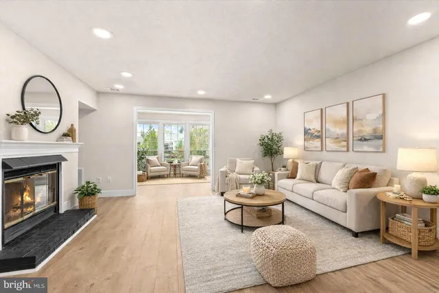 a living room with furniture a fireplace and a mirror