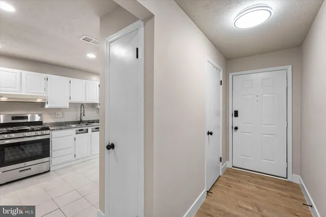a kitchen with cabinets and stainless steel appliances